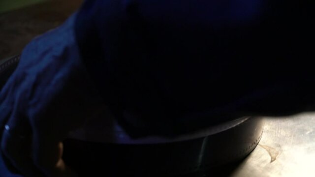 The technician puts a reel with a film on a mounting table