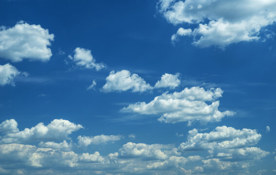 Some light cumuliform clouds in the clean blue sky.