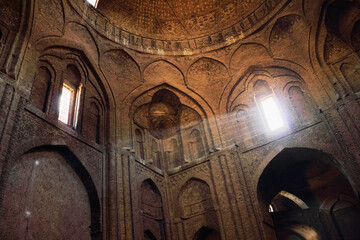 Interior of ancient Jameh (Jame, Masjid) Mosque with rays of light from the window in Esfahan, Iran. It has been a UNESCO World Heritage Site since 2012