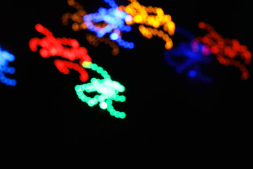 abstract circle line blue and green and orange urban realistic blurred glitter light colorful texture on black.