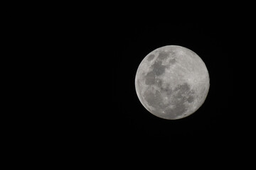 Full moon over the dark sky