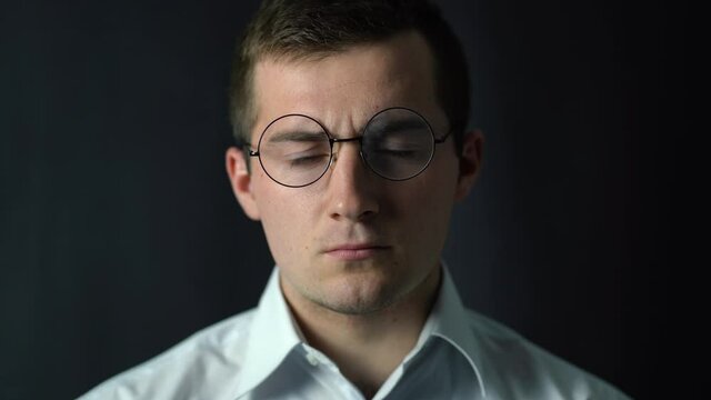 a man puts on glasses and exchanges them for others