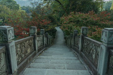 A Chinese stone bridge at the lakeside of West lake in Hangzhou, China, autumn time.