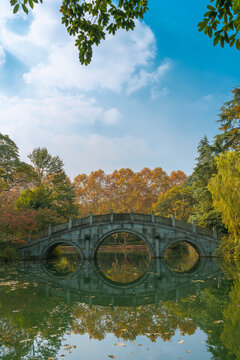 A Chinese stone bridge at the lakeside of West lake in Hangzhou, China, autumn time.