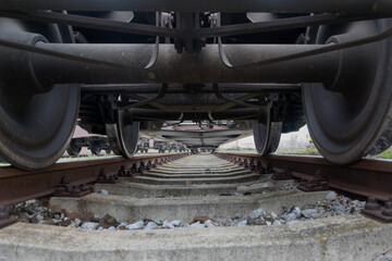 view of the train wheels from below from the tracks