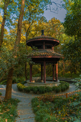 Traditional Chinese garden with pavilion and forest in Hangzhou, China, autumn time.