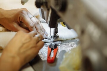 sewing machine scribbling fabric. tailoring at the factory