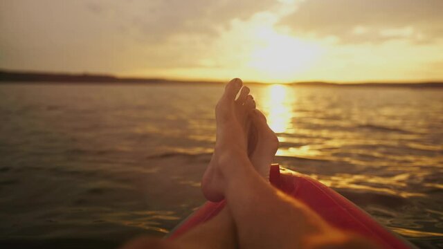 Legs of a relaxed lying person on a boat