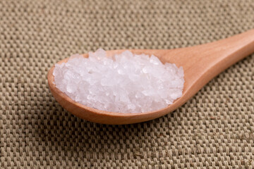 White sea salt in a spoon close-up. Spoon with coarse salt.
