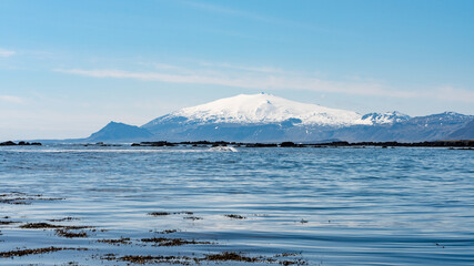 Snæfellsjökull, Snaefellsjokull mountain in west iceland with snowy peak over the ocean from a distance in sunny spring weather