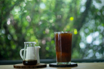 Glass of iced black coffee in cafe.