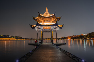 Fototapeta premium Night view of Jixian pavilion, the landmark at the West Lake in Hangzhou, China.