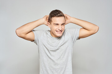 handsome man in light t-shirt cropped view emotion studio isolated background