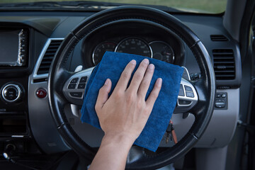 Cleaning car steering wheel with microfiber cloth