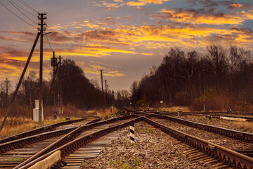 Fototapeta na wymiar Junction of railways track against beautiful sunset sky