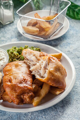 Fish in beer batter and chips with green pea and tartar sauce