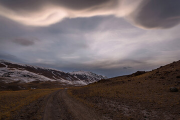 mountains steppe clouds sky road sunset