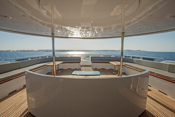 Table and chairs on stern deck of a luxury motor yacht