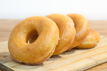 Homemade classic donuts on a on a wooden stand. Breakfast concept.