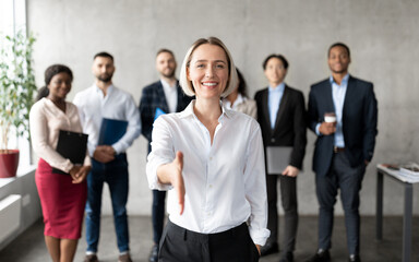Cheerful Businesswoman Stretching Hand For Handshake Greeting Standing In Office