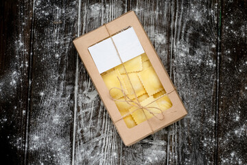 Classic fresh cheese ravioli in a package with an empty label, mock up for box design