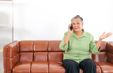 Asian women Retirement Use a smartphone in the living room