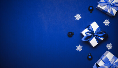 Gift boxes cyan. White gifts with cyan ribbon, New Year balls and winter tree in Christmas...