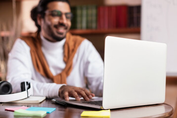 Indian Guy At Laptop Learning Online Having Webinar At Home