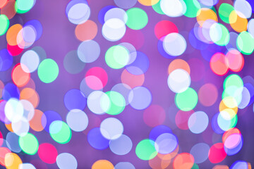 beautiful colored bokeh festive background consisting of multicolored lights out of focus on dark background