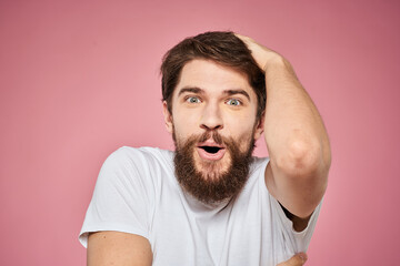 Man in white t-shirt emotions lifestyle facial expression cropped view pink background.