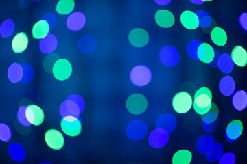 beautiful colored bokeh festive background consisting of multicolored lights out of focus on dark background