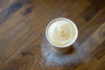Barista prepares coffee in a paper cup