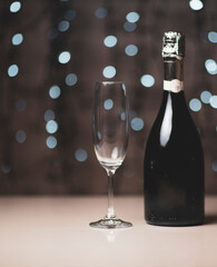 a dark bottle of wine on a beautiful festive bokeh background, composed of colored out of focus lights on a dark background