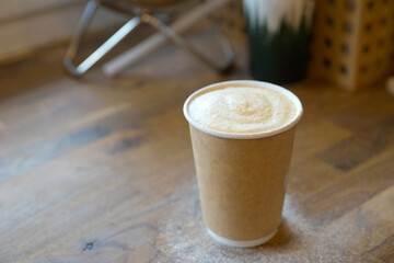 Barista prepares coffee in a paper cup