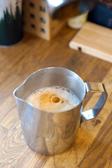 Barista prepares coffee in a paper cup