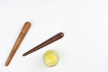 Wooden massage sticks, balm on white background. Reflexology, foot, body care concept. Top view, flat lay, copy space