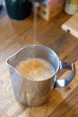 Barista prepares coffee in a paper cup