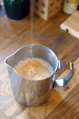 Barista prepares coffee in a paper cup