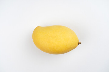 Yellow mango on white background. Tropical fruit, menu, recipe concept. Top view, flat lay, copy space