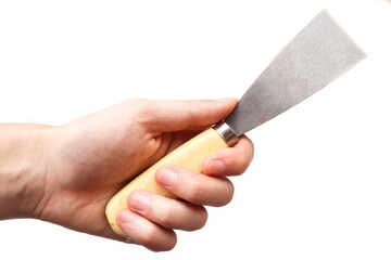 Spatula in the hand of a worker isolated on white background. A hand raised up holds a construction tool