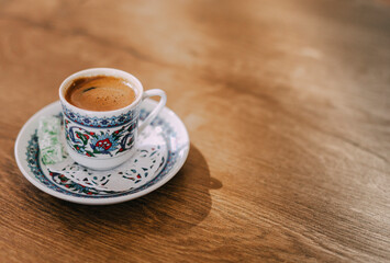 Cup of turkish coffee on wooden table. Copy space left side. Macro shoot, close up. 