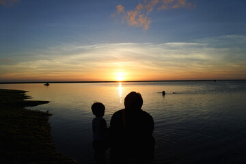 Daddy and son with sunset
