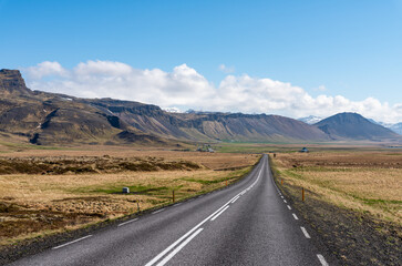 Road going into the distance in beautiful sunny scenic landscape in iceland