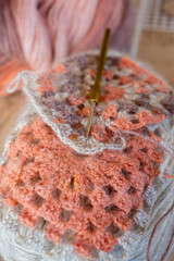 Close-up, grey and multi colored yarns and crochet needle. 