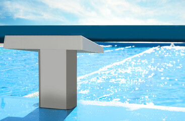 Fototapeta na wymiar Starting platform near outdoor swimming pool on sunny day