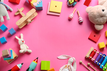 Frame of different toys on pink background, flat lay. Space for text