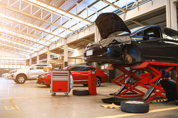 Fototapeta premium car in automobile repair service center with soft-focus and over light in the background