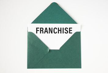 Franchise text on white paper in a green envelope.