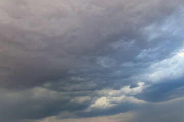 Dark storm clouds in sky before thunderstorm and rain. Dramatic sky background