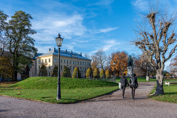Obraz premium Unrecognizable people in Carl Johans Park during fall in Norrköping, Sweden. Norrköping is a historic industrial town in Sweden.